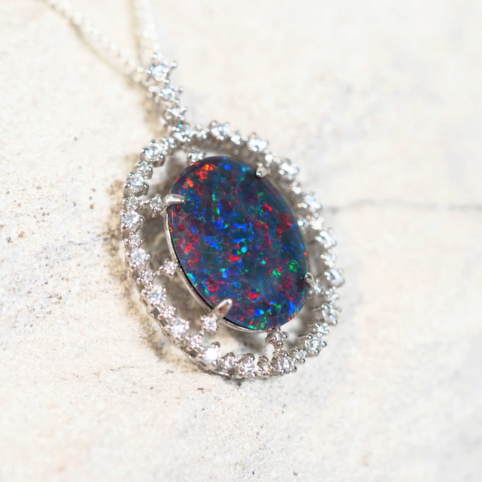 statement opal pendant with a ring of diamantes