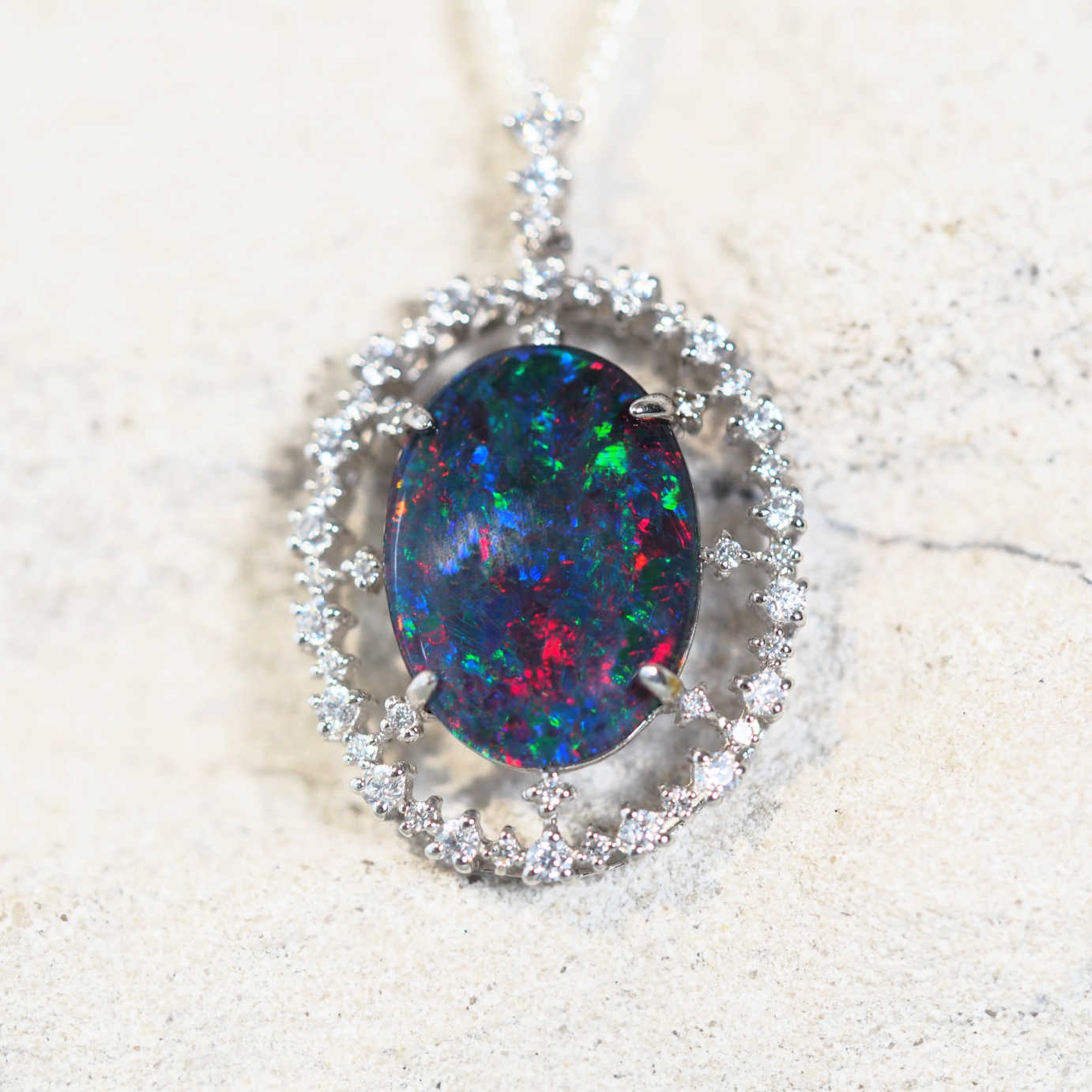 colourful opal pendant surrounded by 47 sparkling cubic zirconias