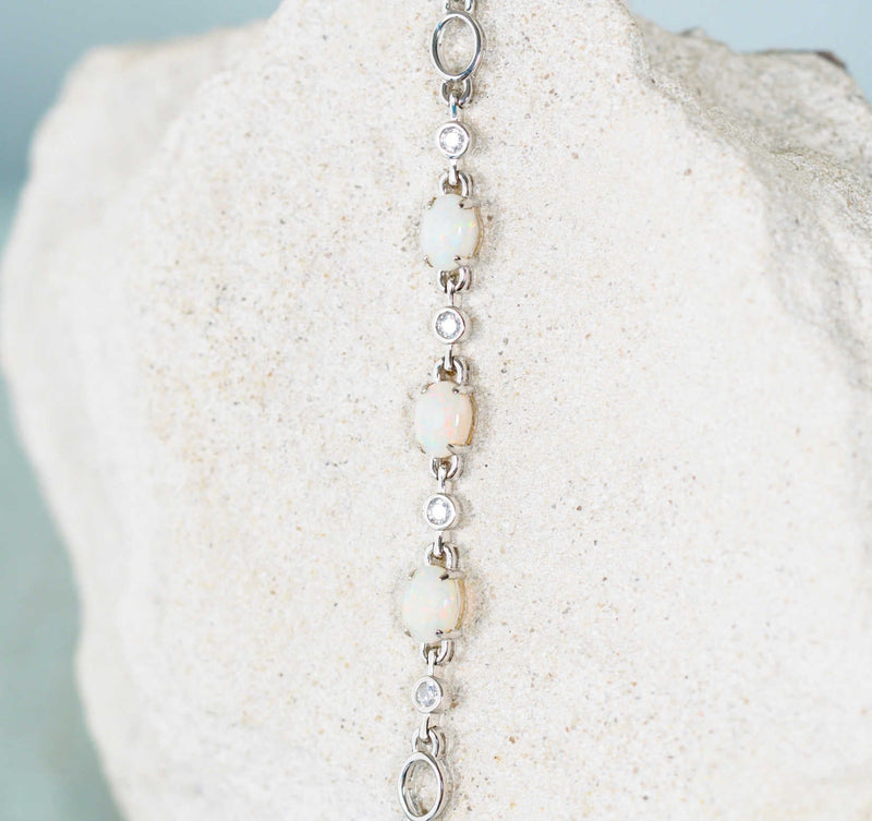 Elegant sterling silver opal bracelet with three multi-coloured South Australian solid white opals and 10 dazzling crystal embellishments.