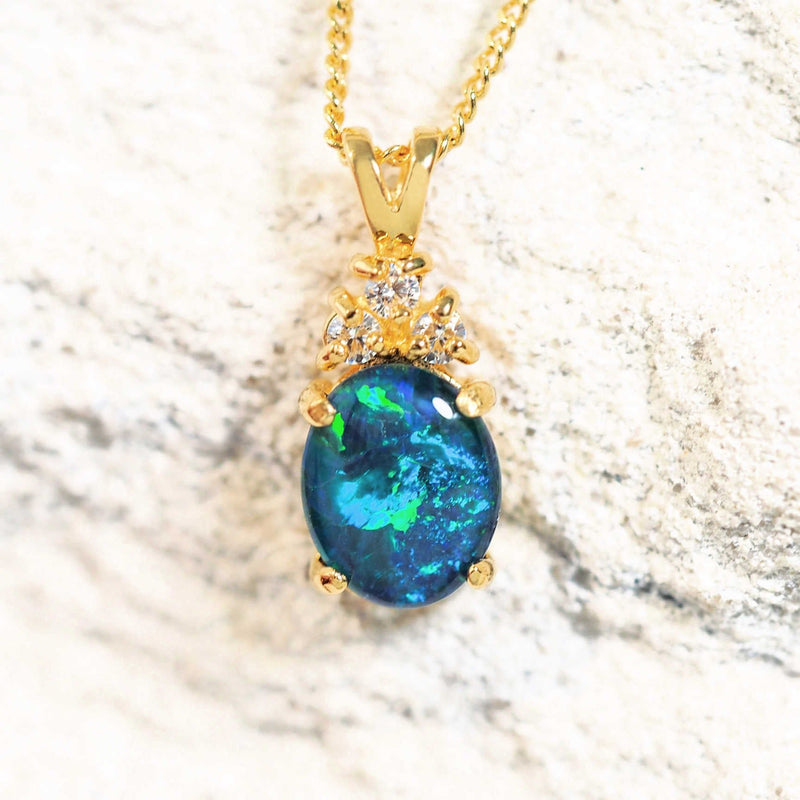 Gold-plated silver pendant featuring a vibrant blue and green opal gemstone