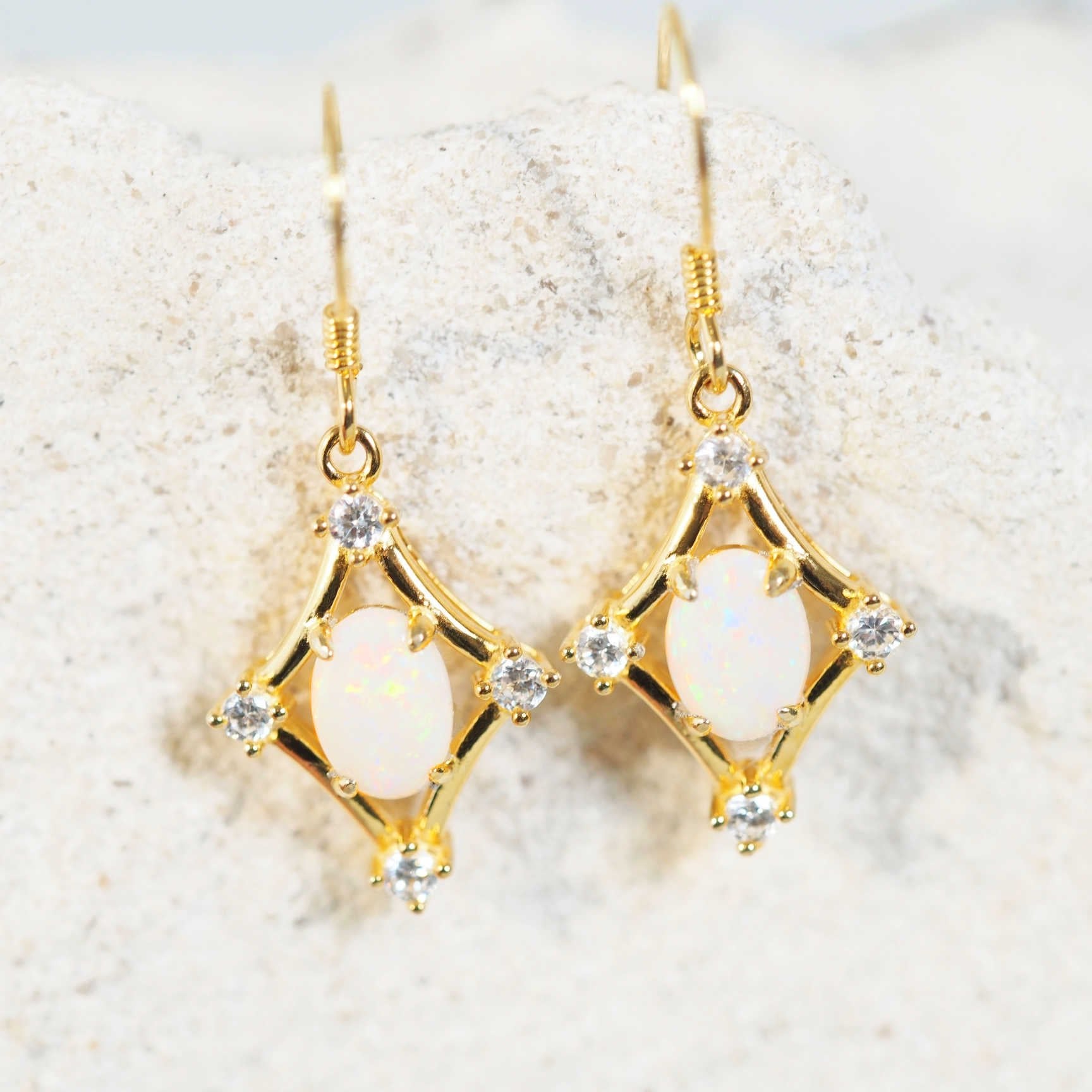 white opal earrings set in gold plated silver