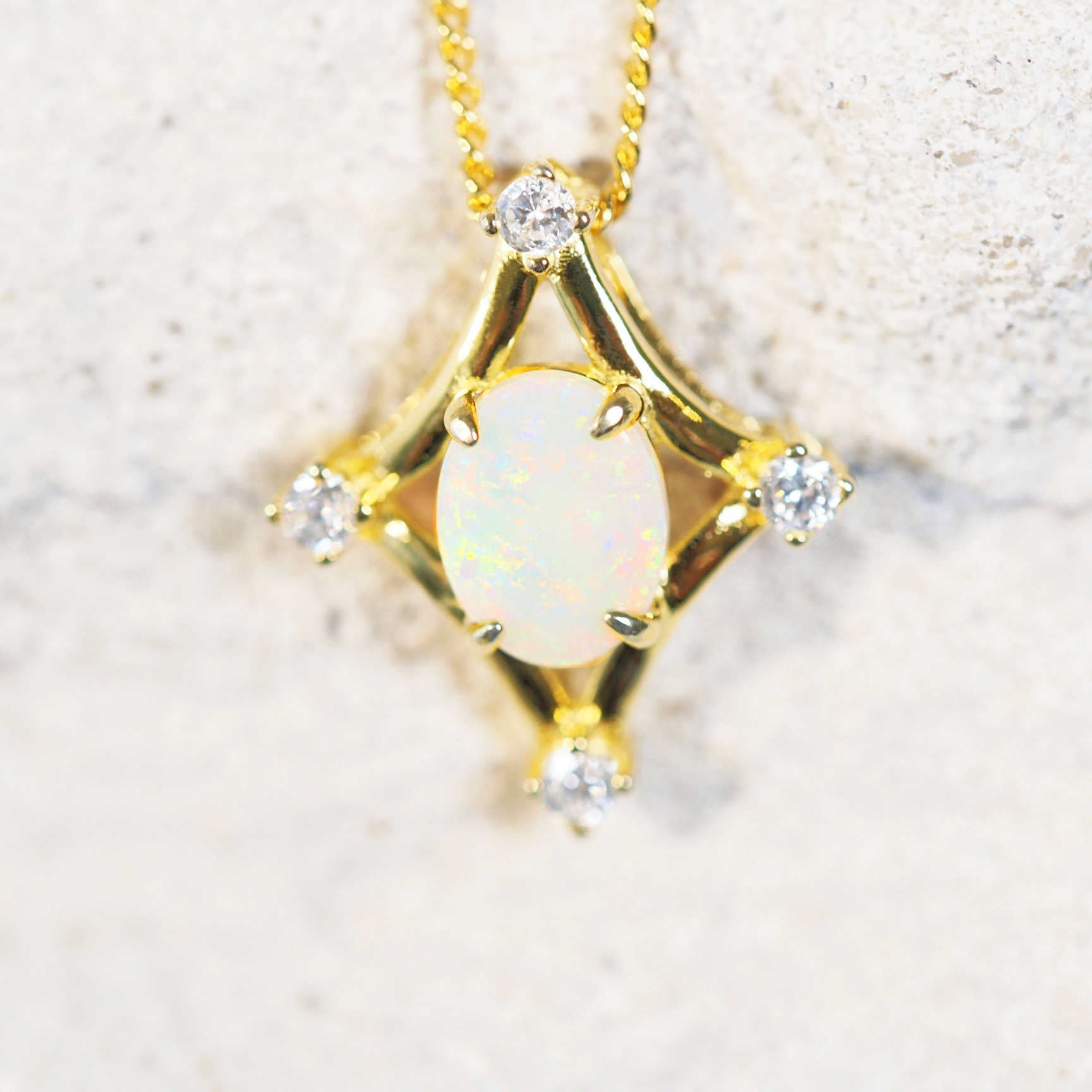 white opal pendant set on gold plated silver