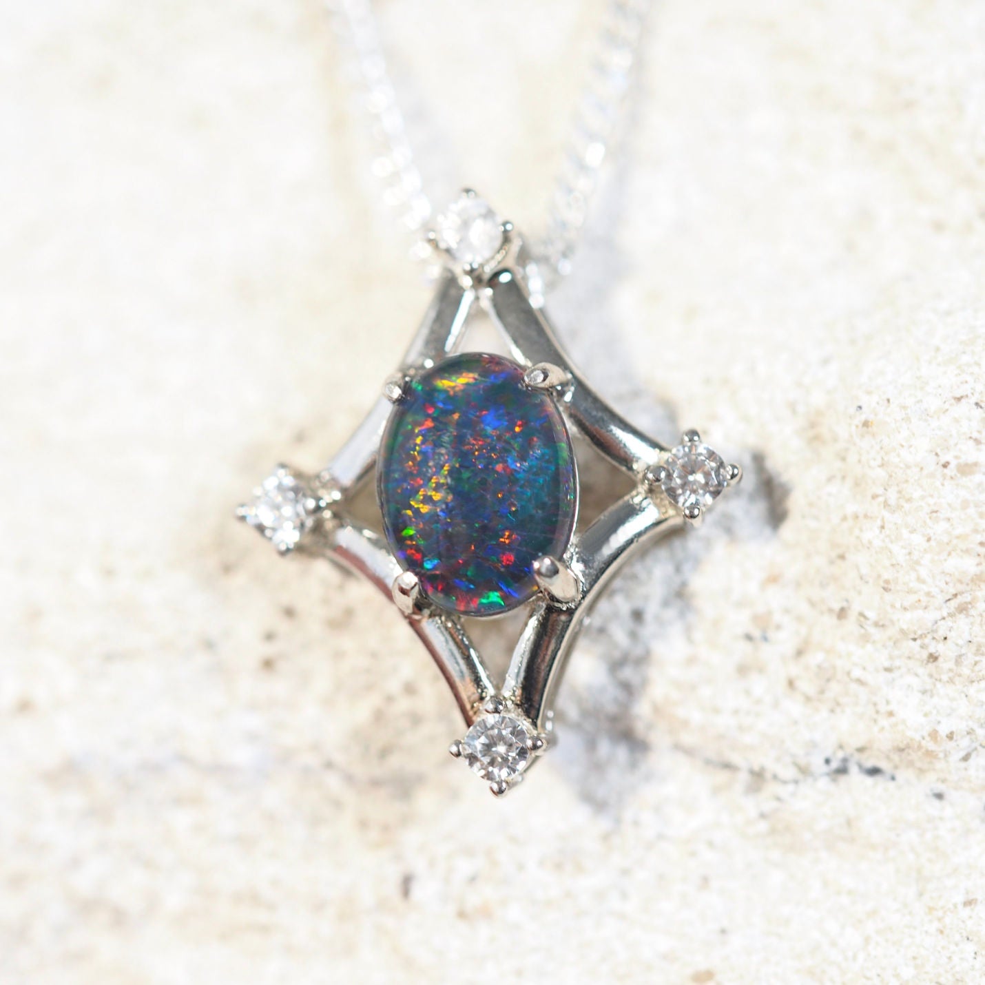 opal pendant set in sterling silver with four diamantes