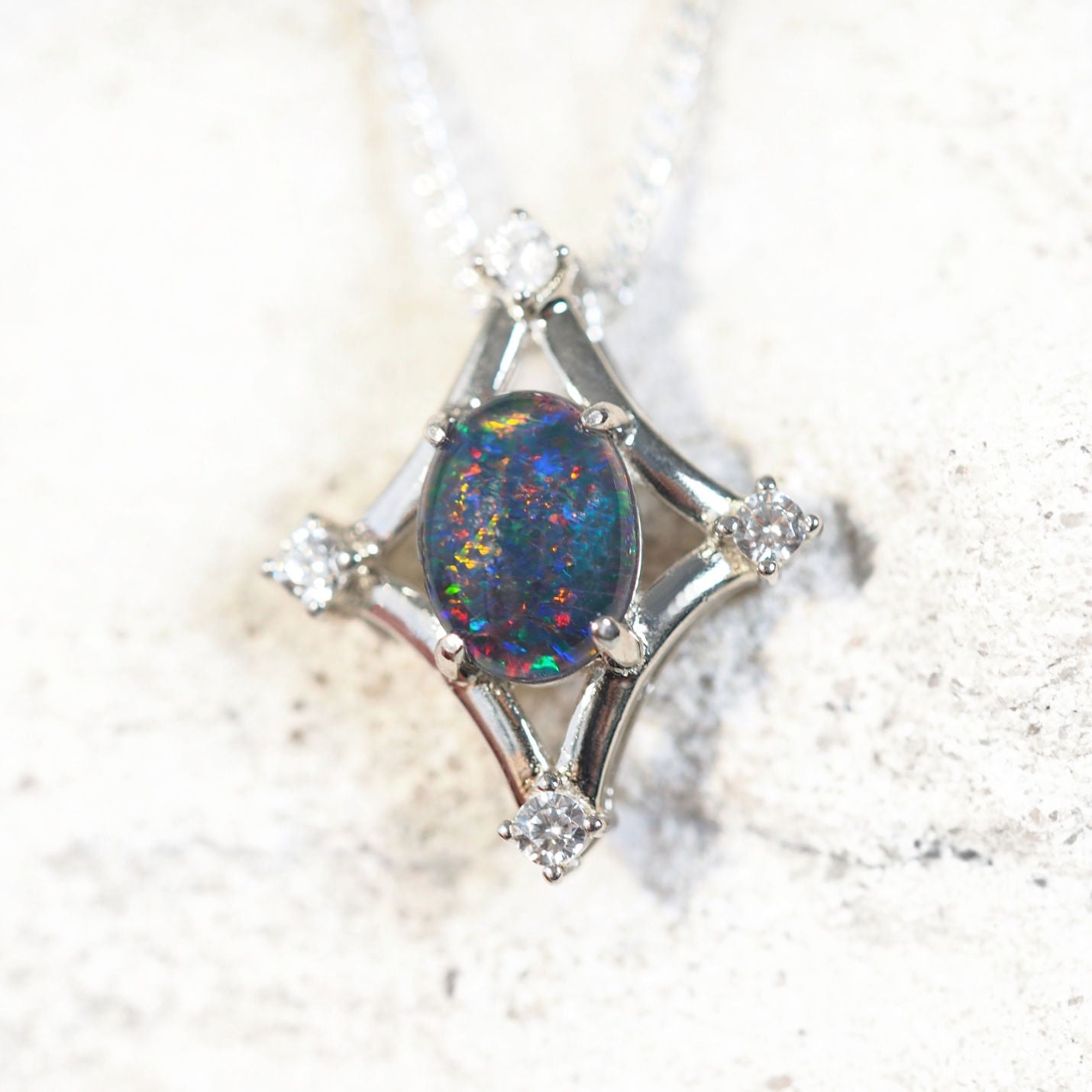 opal pendant set in sterling silver with four diamantes