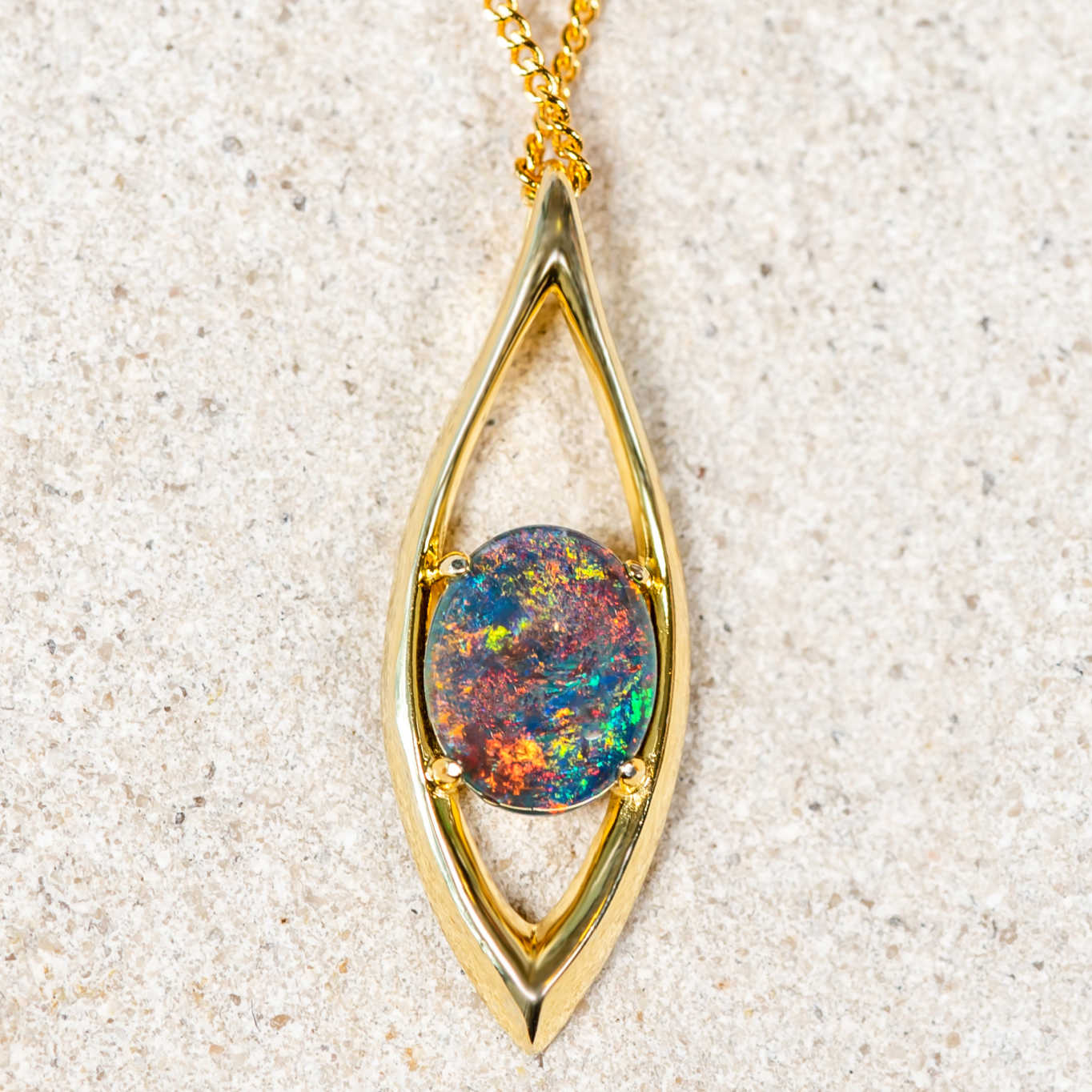 Beautiful marquise-shaped gold plated sterling silver necklace pendant claw set with a brilliant multi-coloured round-oval Australian triplet opal.